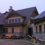 A large house featuring a prominent roof, showcasing its architectural design and spacious structure.